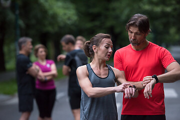 Image showing sporty couple using smart watches