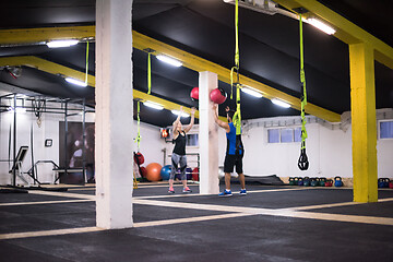 Image showing young athletes couple working out with medical ball