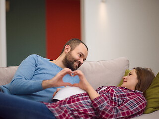 Image showing man and pregnant woman showing heart sign