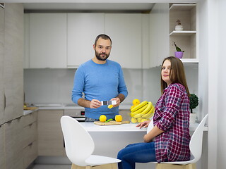 Image showing couple cooking food fruit lemon juice at kitchen