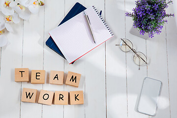 Image showing TEAM WORK. Message at at wooden cubes on a desk background.