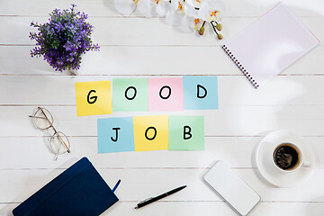 Image showing GOOD JOB. Message at colorful note papers on a desk background.