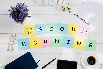 Image showing GOOD MORNING. Message at colorful note papers on a desk background.