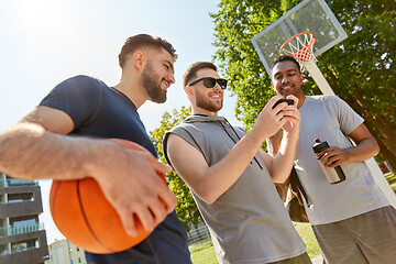 Image showing men with smartphone on basketball playground