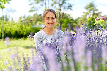 Image showing young woman and lavender flowers at summer garden