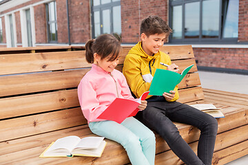 Image showing school children with notebooks sitting on bench