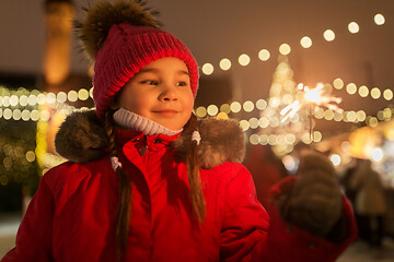 Image showing happy girl with sparkler at christmas market