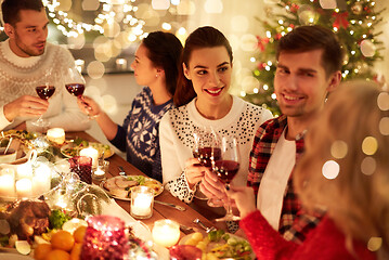 Image showing happy friends celebrating christmas at home feast