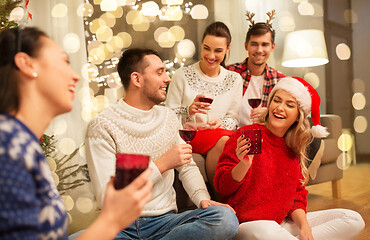 Image showing friends celebrating christmas and drinking wine