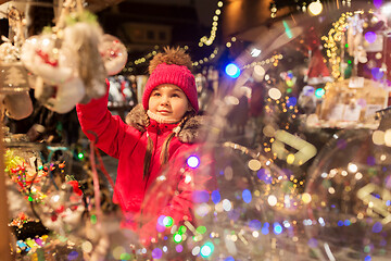 Image showing girl choosing christmas decorations at market