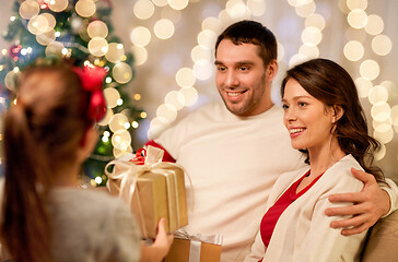 Image showing happy family with christmas present at home