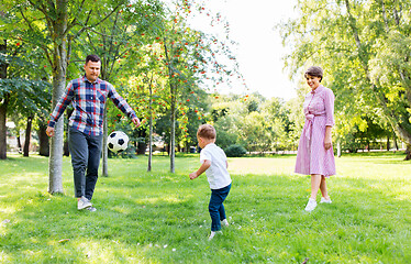 Image showing happy family playing soccer at summer park