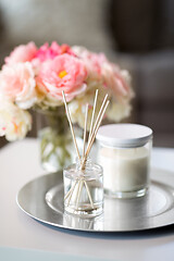 Image showing aroma reed diffuser, candle and flowers on table