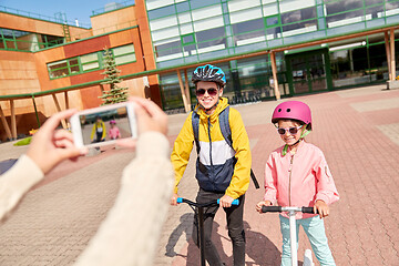 Image showing school kids with scooters photographing by cell