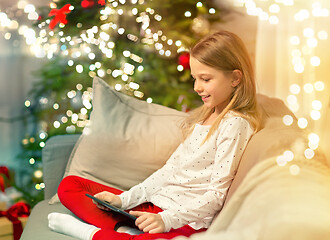 Image showing smiling girl with tablet pc at christmas home