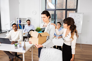 Image showing colleague soothing sad fired female office worker