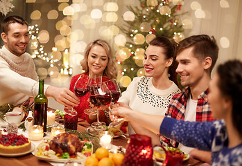 Image showing friends celebrating christmas and drinking wine