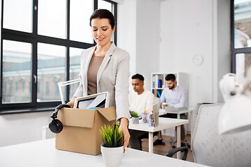 Image showing happy businesswoman with personal stuff at office