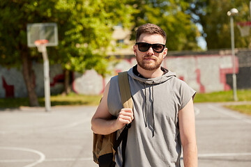 Image showing man with backpack at street basketball playground