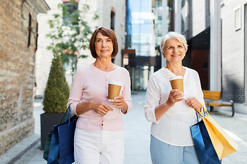 Image showing senior women with shopping bags and coffee in city