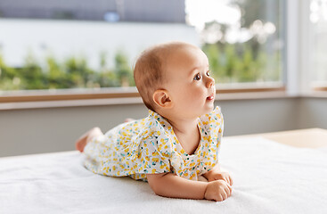 Image showing sweet baby girl lying on white blanket