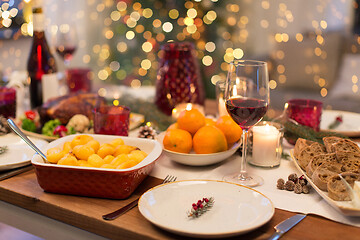 Image showing glass of red wine and food on christmas table