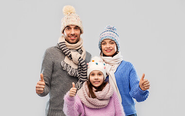 Image showing happy family in winter clothes on grey background