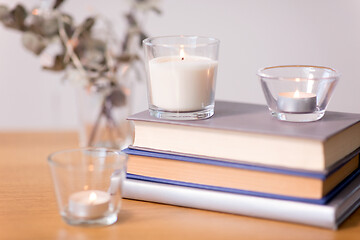 Image showing fragrance candles burning and books on table