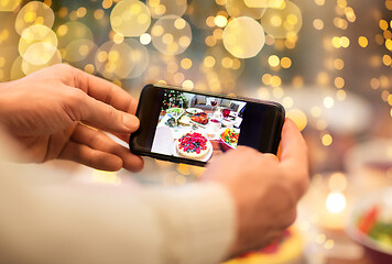 Image showing hands photographing food at christmas dinner