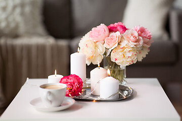 Image showing coffee, candles, garland and flowers on table