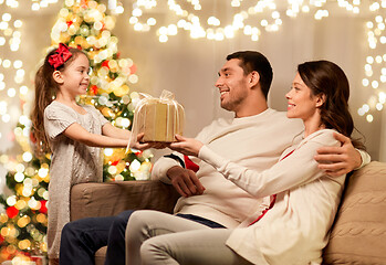 Image showing happy family with christmas present at home