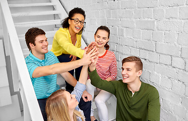 Image showing teenage friends or students making high five