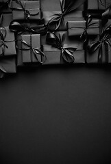 Image showing A pile various size black boxed gifts placed on stack. Christmas concept.