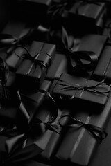 Image showing A pile various size black boxed gifts placed on stack. Christmas concept.