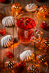 Image showing Spicy winter tea or punch with anise and meringue pastry