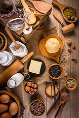 Image showing Assortment of baking ingredients and kitchen utensils in vintage wooden style