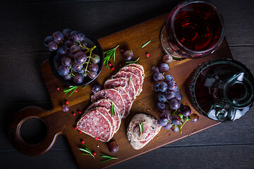 Image showing Saltufo - Italian salami delicacy, salami with summer truffle coated with Parmesan cheese with red wine and grapes