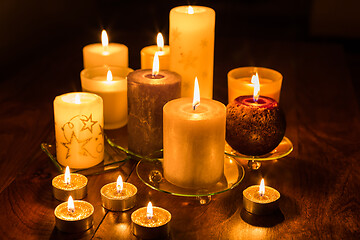 Image showing Candles on wooden background. Candlelights for Christmas.