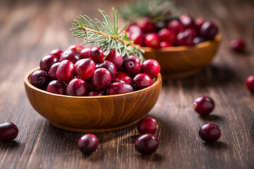 Image showing Ripe organic cranberries in wooden bowl on wooden background