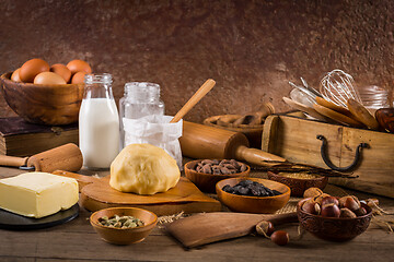 Image showing Assortment of baking ingredients and kitchen utensils in vintage wooden style