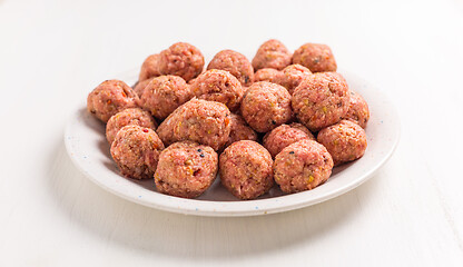 Image showing Raw meatballs on plate and white background