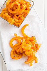 Image showing Spicy seasoned curly fries. Ready to eat.