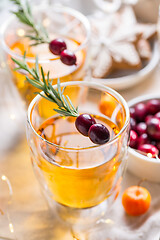 Image showing Christmas apple cider cocktail with cranberries and rosemary