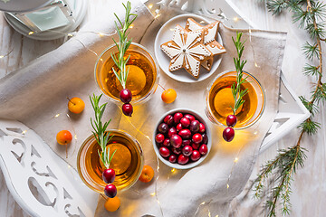 Image showing Christmas apple cider cocktail with cranberries and rosemary