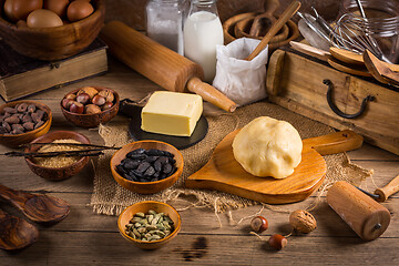 Image showing Assortment of baking ingredients and kitchen utensils in vintage wooden style