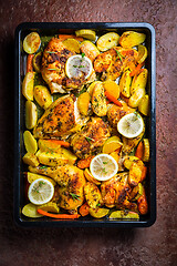 Image showing Baked lemon chicken with potates, carrots and herbs