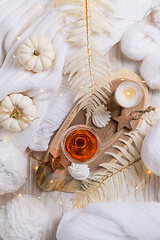 Image showing Cosy still life for winter and autumn with glass of pink wine, pumpkin and cookie