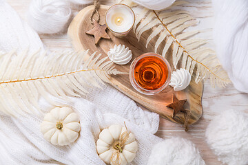 Image showing Cosy still life for winter and autumn with glass of pink wine, pumpkin and cookie