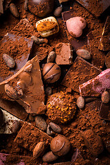 Image showing Variation of chocolate and candy with cocoa and cocoa beans as background