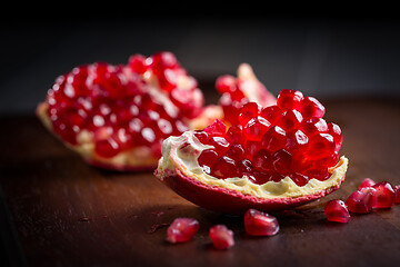 Image showing Fresh organic pomegranate on wooding cutting board